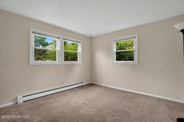 carpeted empty room with baseboard heating and baseboards