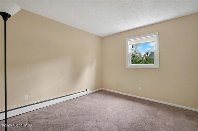 carpeted spare room with a baseboard heating unit and baseboards