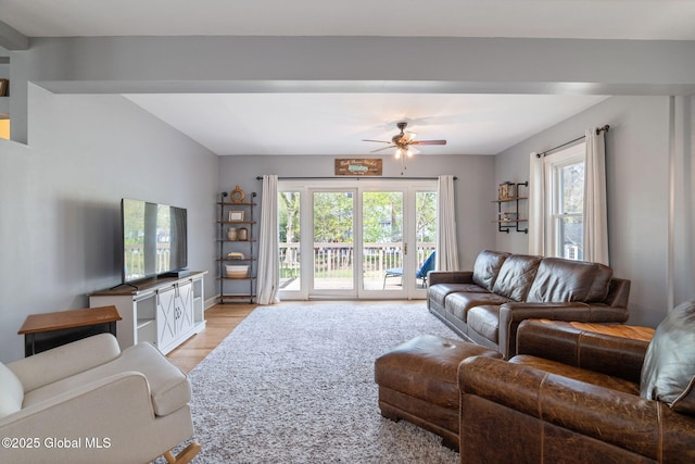 living area with a ceiling fan and light wood-type flooring