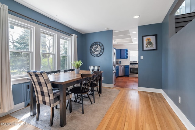 dining space with recessed lighting, light wood finished floors, and baseboards