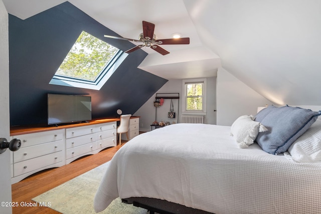 bedroom featuring ceiling fan, wood finished floors, and lofted ceiling