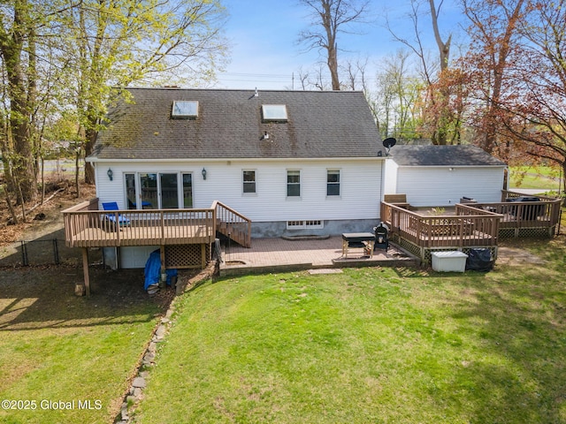 back of house with roof with shingles, a wooden deck, a yard, and fence