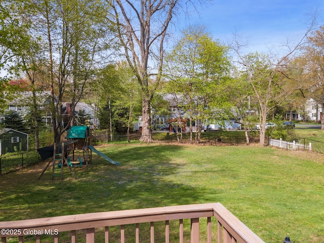 view of yard featuring fence and a playground