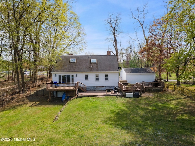 back of property with a chimney, a fenced backyard, a yard, and a deck