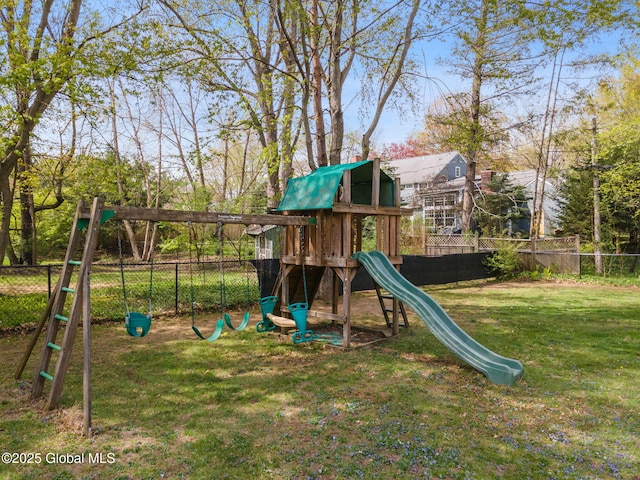 view of playground featuring fence and a yard