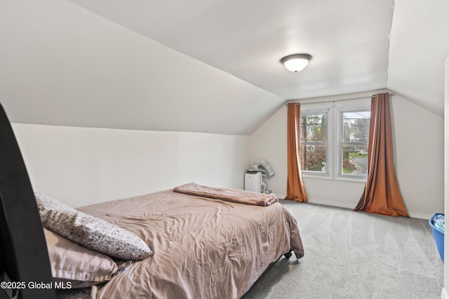 bedroom featuring carpet, lofted ceiling, and baseboards