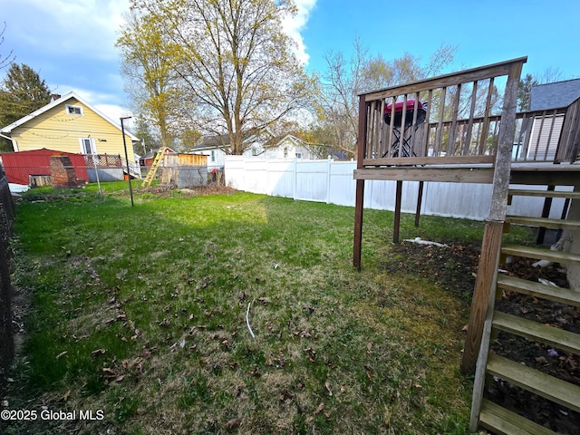 view of yard with a deck and fence