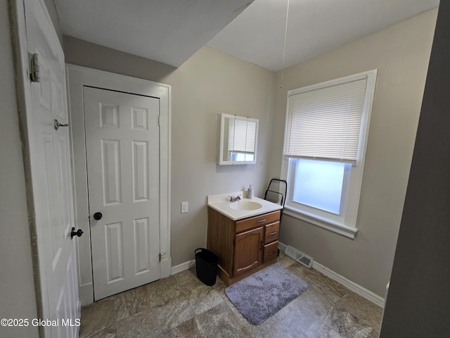 bathroom with vanity, baseboards, and visible vents
