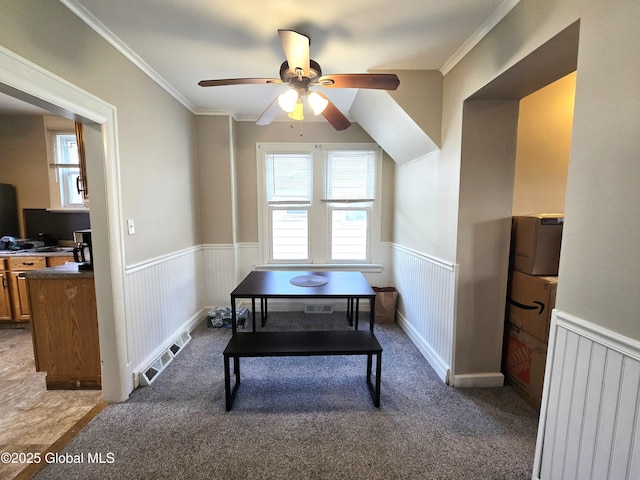 office featuring a ceiling fan, a wainscoted wall, and a healthy amount of sunlight