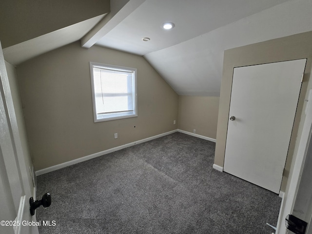 additional living space with carpet floors, baseboards, and vaulted ceiling