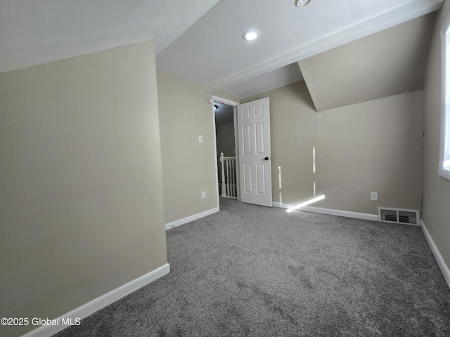 bonus room featuring visible vents, baseboards, carpet floors, and lofted ceiling