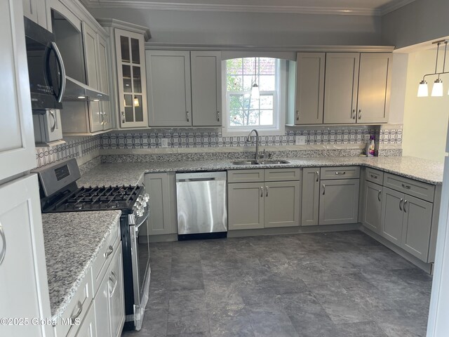 kitchen with crown molding, tasteful backsplash, a sink, glass insert cabinets, and stainless steel appliances