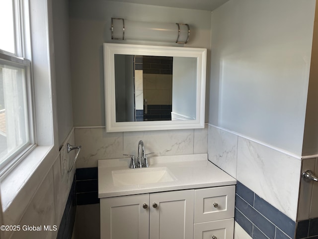 bathroom with tile walls and vanity
