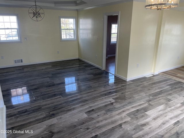 unfurnished dining area featuring an inviting chandelier, ornamental molding, plenty of natural light, and visible vents