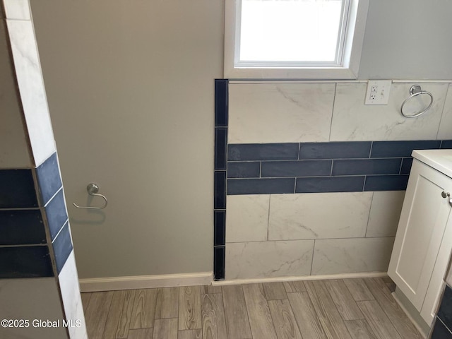 bathroom with wood finished floors and vanity