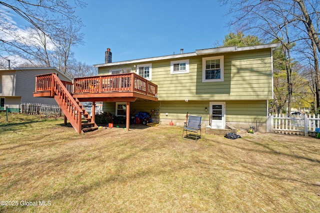 rear view of house featuring stairs, a deck, a fenced backyard, a chimney, and a lawn