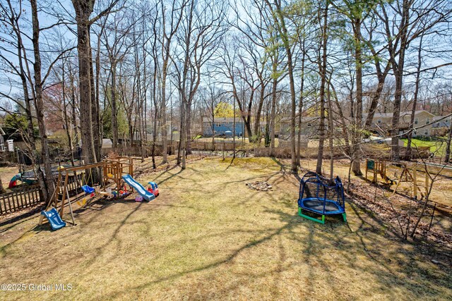 view of yard with a playground and fence