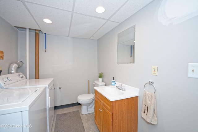 bathroom featuring independent washer and dryer, vanity, toilet, a paneled ceiling, and recessed lighting