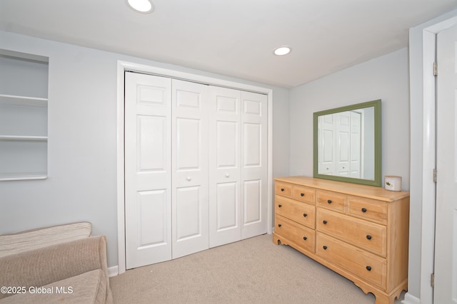 interior space featuring light colored carpet, recessed lighting, baseboards, and a closet