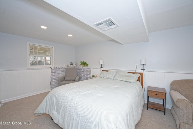 bedroom with light colored carpet, visible vents, wainscoting, and recessed lighting