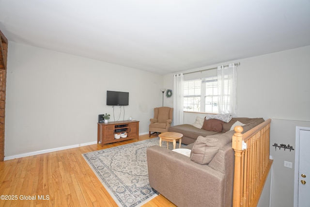 living room with baseboards and wood finished floors