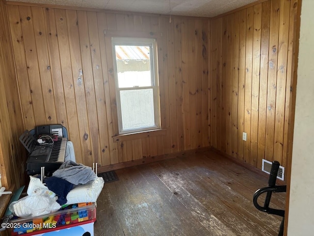 misc room with wood walls and hardwood / wood-style flooring