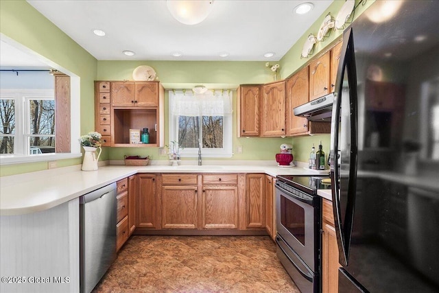 67 Fairlawn Dr, Colonie, NY 12110 - kitchen featuring appliances with stainless steel finishes, under cabinet range hood, healthy amount of natural light, light countertops, and recessed lighting