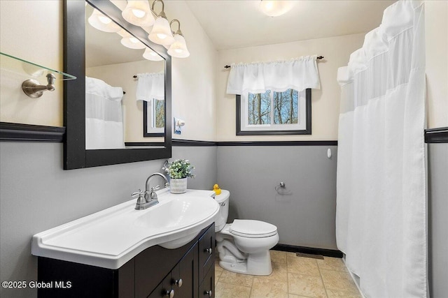 67 Fairlawn Dr, Colonie, NY 12110 - full bathroom featuring toilet, vanity, and baseboards
