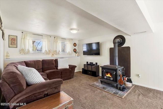 67 Fairlawn Dr, Colonie, NY 12110 - carpeted living area featuring a wood stove and baseboards