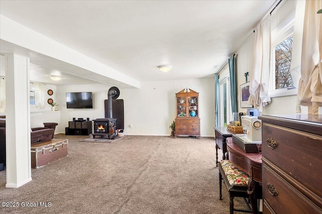 67 Fairlawn Dr, Colonie, NY 12110 - living area with carpet floors, a wood stove, and baseboards