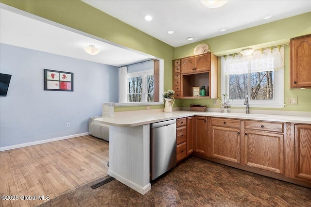 67 Fairlawn Dr, Colonie, NY 12110 - kitchen featuring dishwasher, a sink, a peninsula, light countertops, and recessed lighting