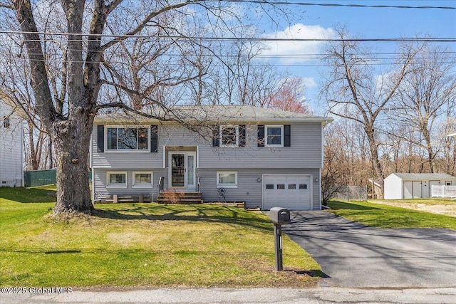 67 Fairlawn Dr, Colonie, NY 12110 - bi-level home featuring asphalt driveway and an attached garage