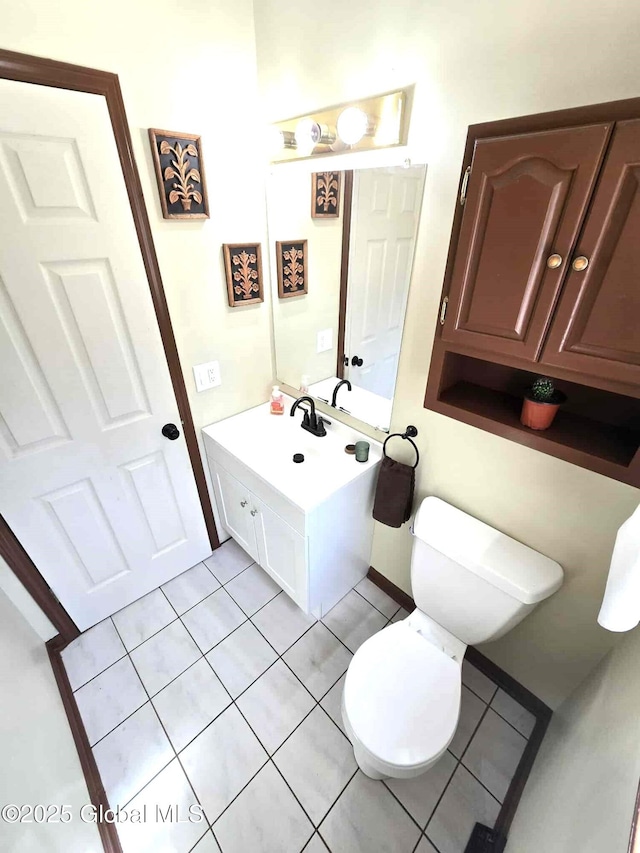 bathroom featuring toilet, tile patterned floors, and vanity