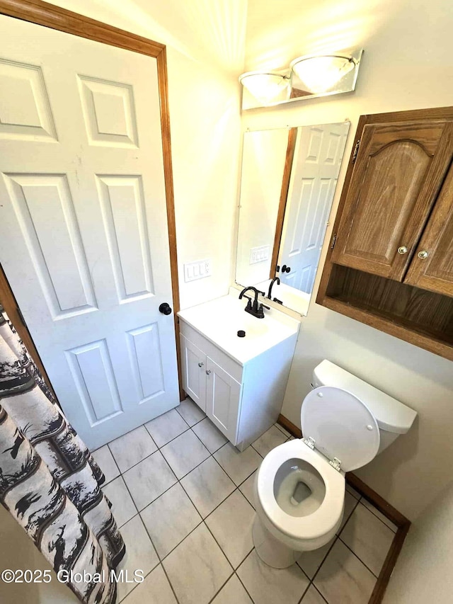 bathroom with tile patterned flooring, toilet, and vanity