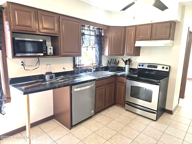 kitchen featuring a sink, light tile patterned flooring, under cabinet range hood, a ceiling fan, and appliances with stainless steel finishes