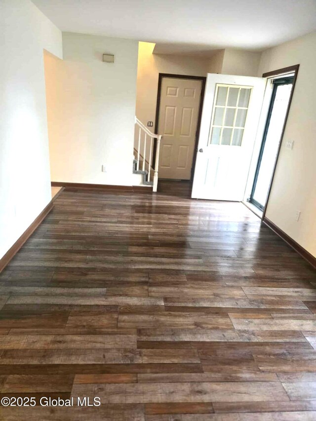 interior space with stairway, baseboards, and wood finished floors