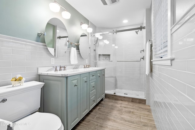 73 Railroad Pl Unit 403-404, Saratoga Springs, Inside, NY 12866 - full bath with tile walls, toilet, a stall shower, double vanity, and wood finished floors
