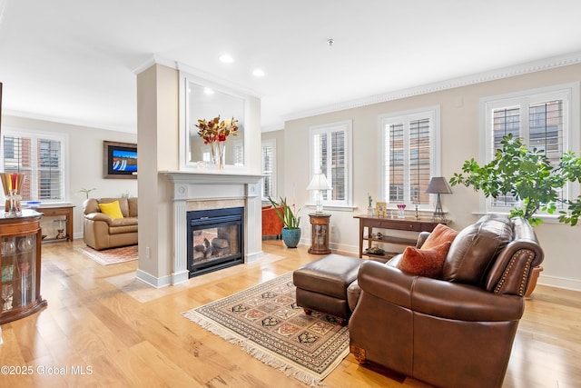 73 Railroad Pl Unit 403-404, Saratoga Springs, Inside, NY 12866 - living area featuring ornamental molding, a multi sided fireplace, plenty of natural light, recessed lighting, and light wood-style flooring