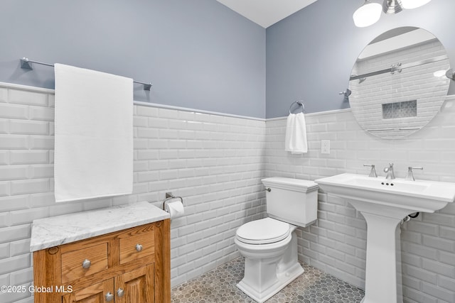 73 Railroad Pl Unit 403-404, Saratoga Springs, Inside, NY 12866 - full bathroom featuring toilet, a wainscoted wall, tile walls, and tile patterned floors
