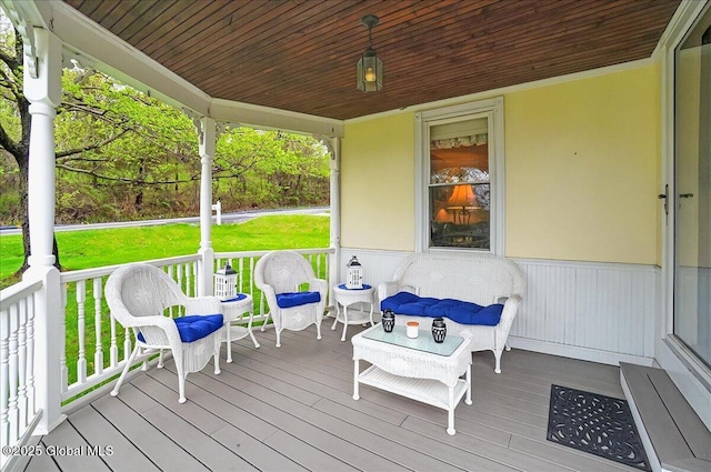 wooden terrace featuring a yard