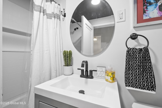 bathroom featuring vanity, shower / bath combo with shower curtain, and toilet
