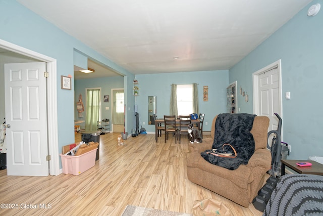 living room with baseboards and wood finished floors