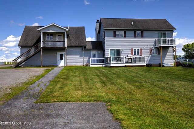 373 County Route 42, Fort Edward, NY 12828 - back of property featuring a yard, roof with shingles, and a wooden deck