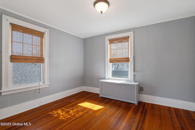 unfurnished room featuring crown molding, radiator, baseboards, and hardwood / wood-style floors
