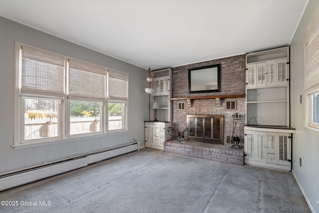 unfurnished living room with carpet, baseboards, baseboard heating, and a fireplace