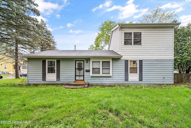 traditional home with a front lawn and fence
