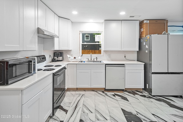 kitchen with a sink, stainless steel appliances, white cabinets, under cabinet range hood, and light countertops