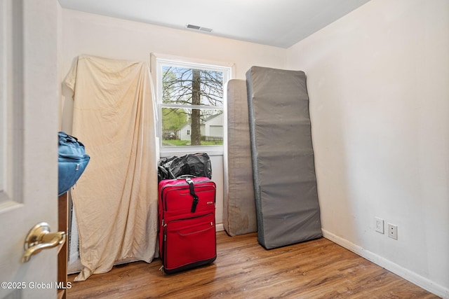 misc room with visible vents, wood finished floors, and baseboards