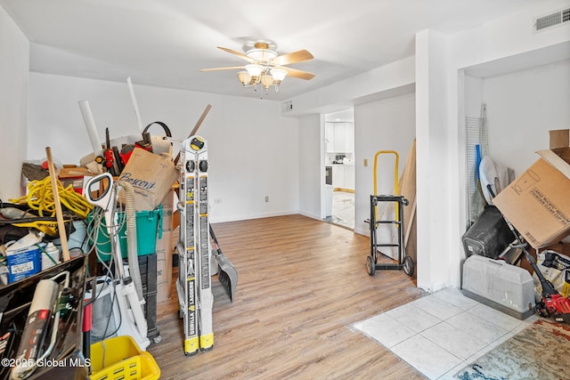 interior space featuring ceiling fan, visible vents, and wood finished floors