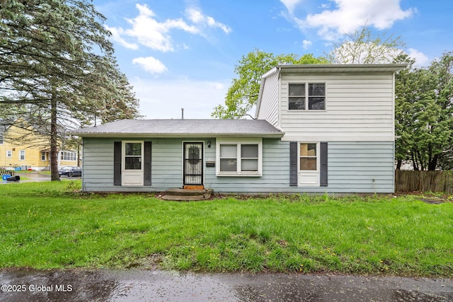 traditional home with fence and a front yard